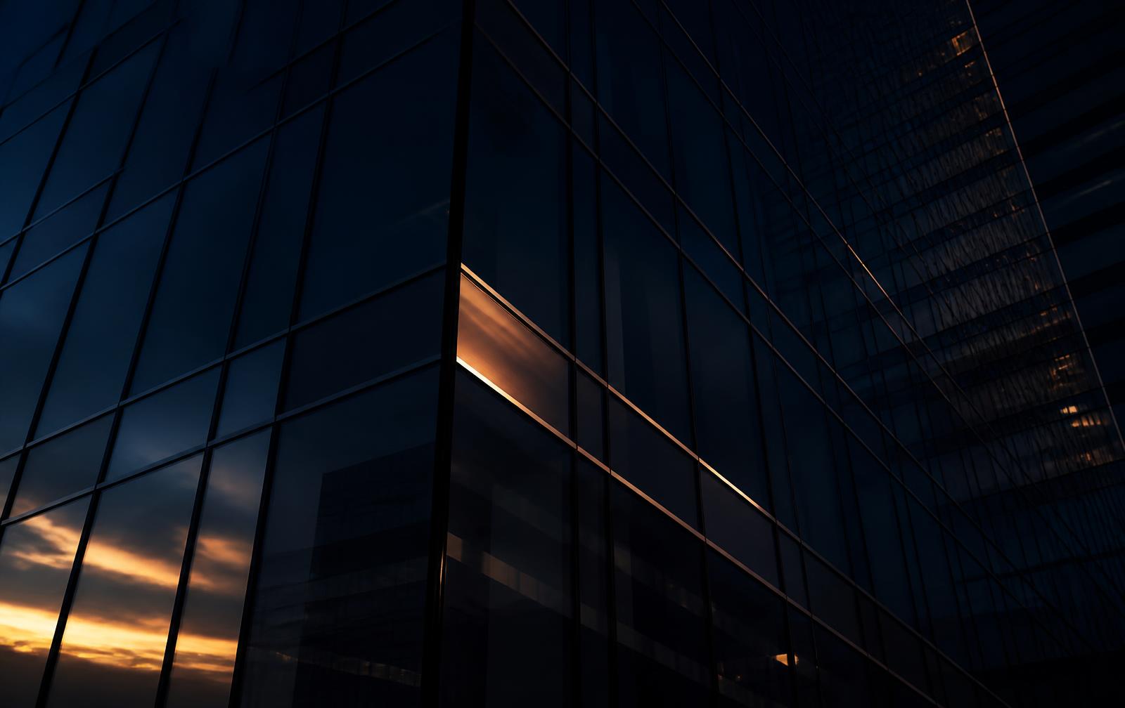 Abstract glass tower facade reflecting dusk light